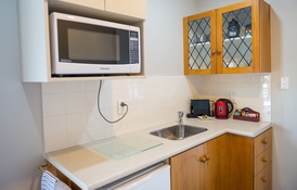 kitchen with microwave and fridge